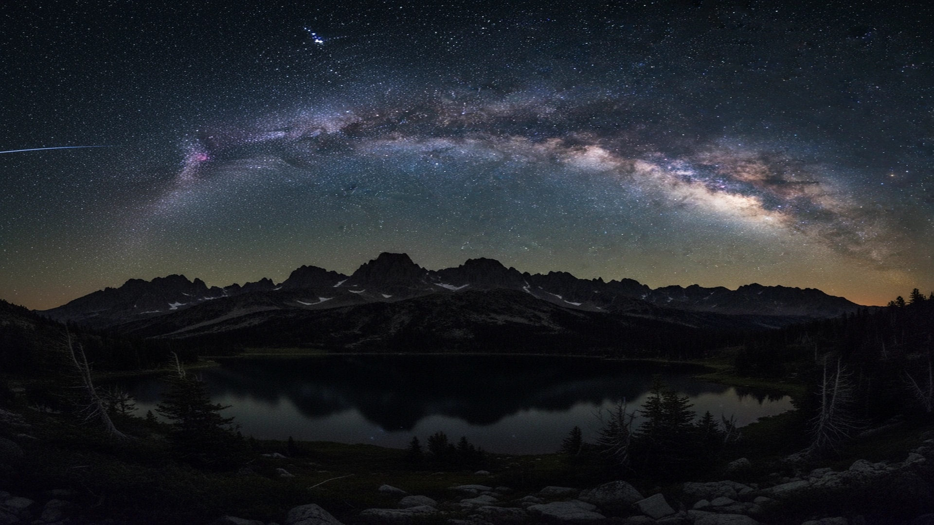 Mountain silhouette against starry night sky
